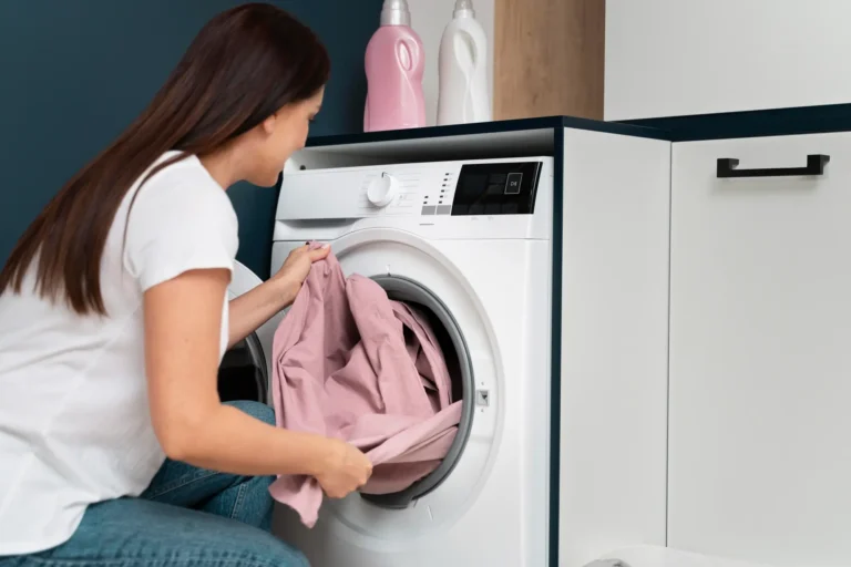 Woman loading clothes into front-load washing machine in Tampa home laundry room