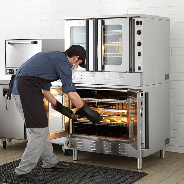 Technician loading trays into commercial convection oven during service in Tampa restaurant