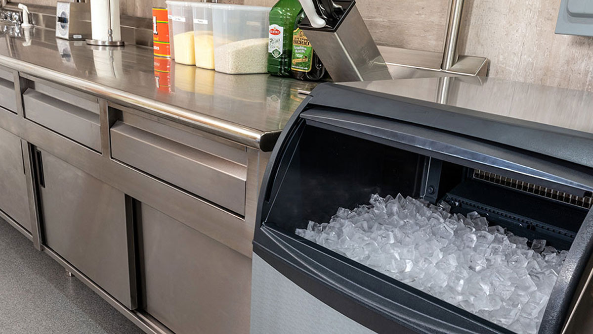 Commercial ice bin filled with fresh ice in stainless steel restaurant kitchen Tampa